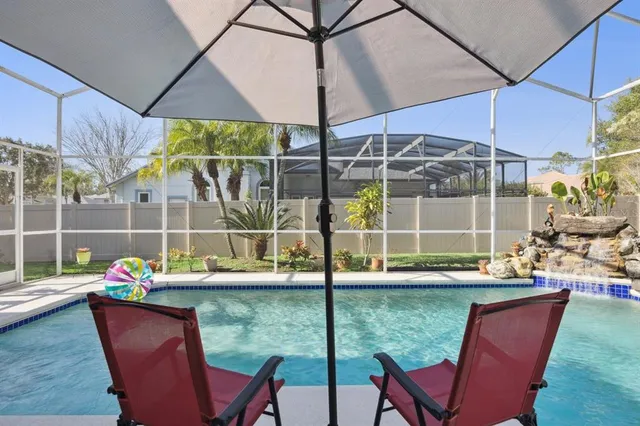 a view of a house with a garden and mountains