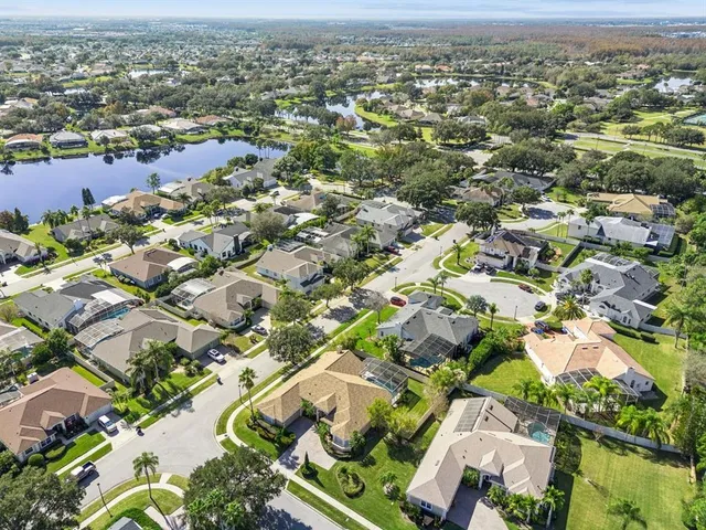 an aerial view of a house with a garden and swimming pool