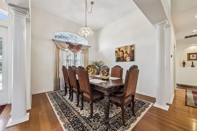 a view of a dining room with furniture wooden floor and chandelier