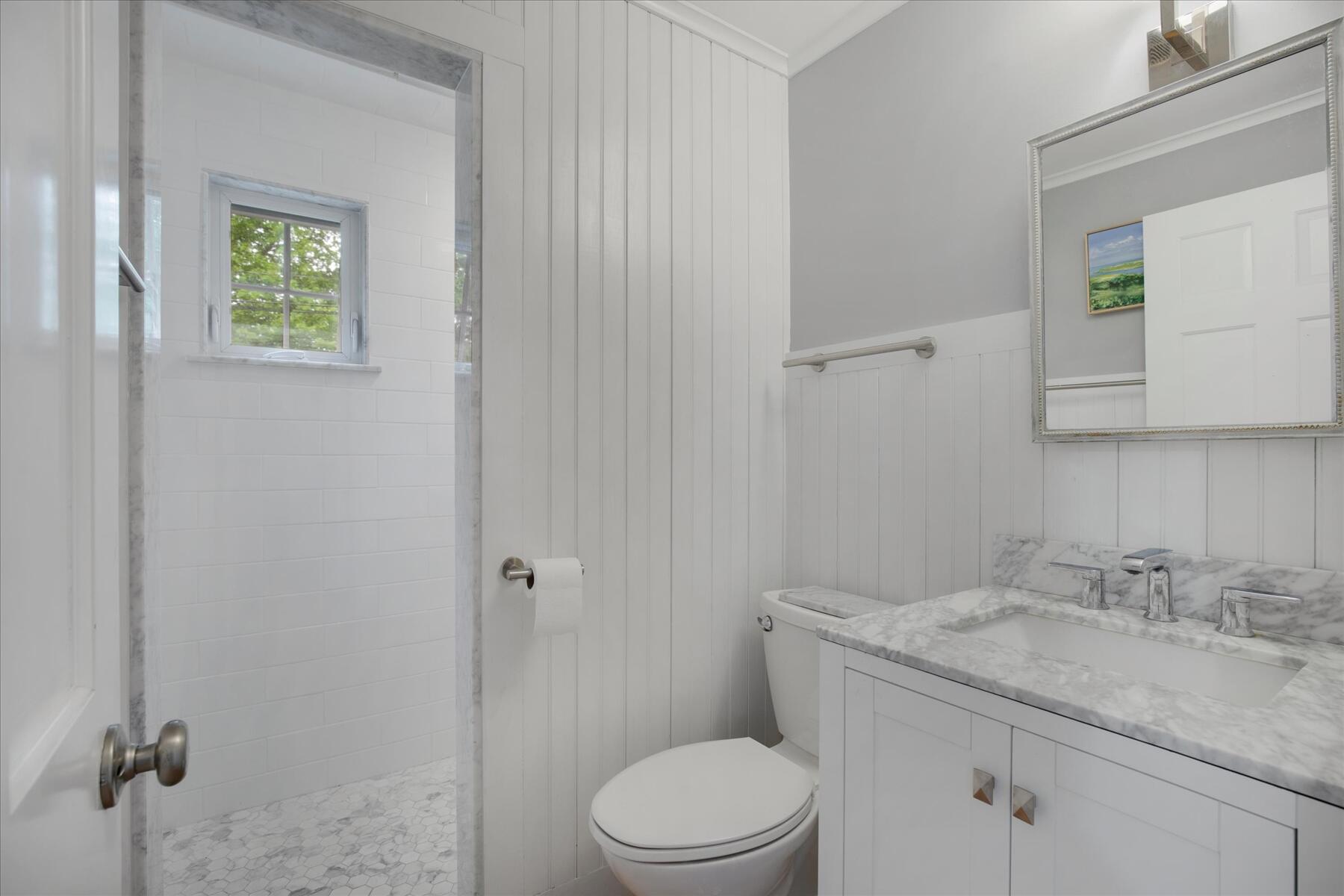 21 Quaker Road East Sandwich, MA 02537 - Photo 29 of 43 a bathroom with a granite countertop toilet sink and mirror