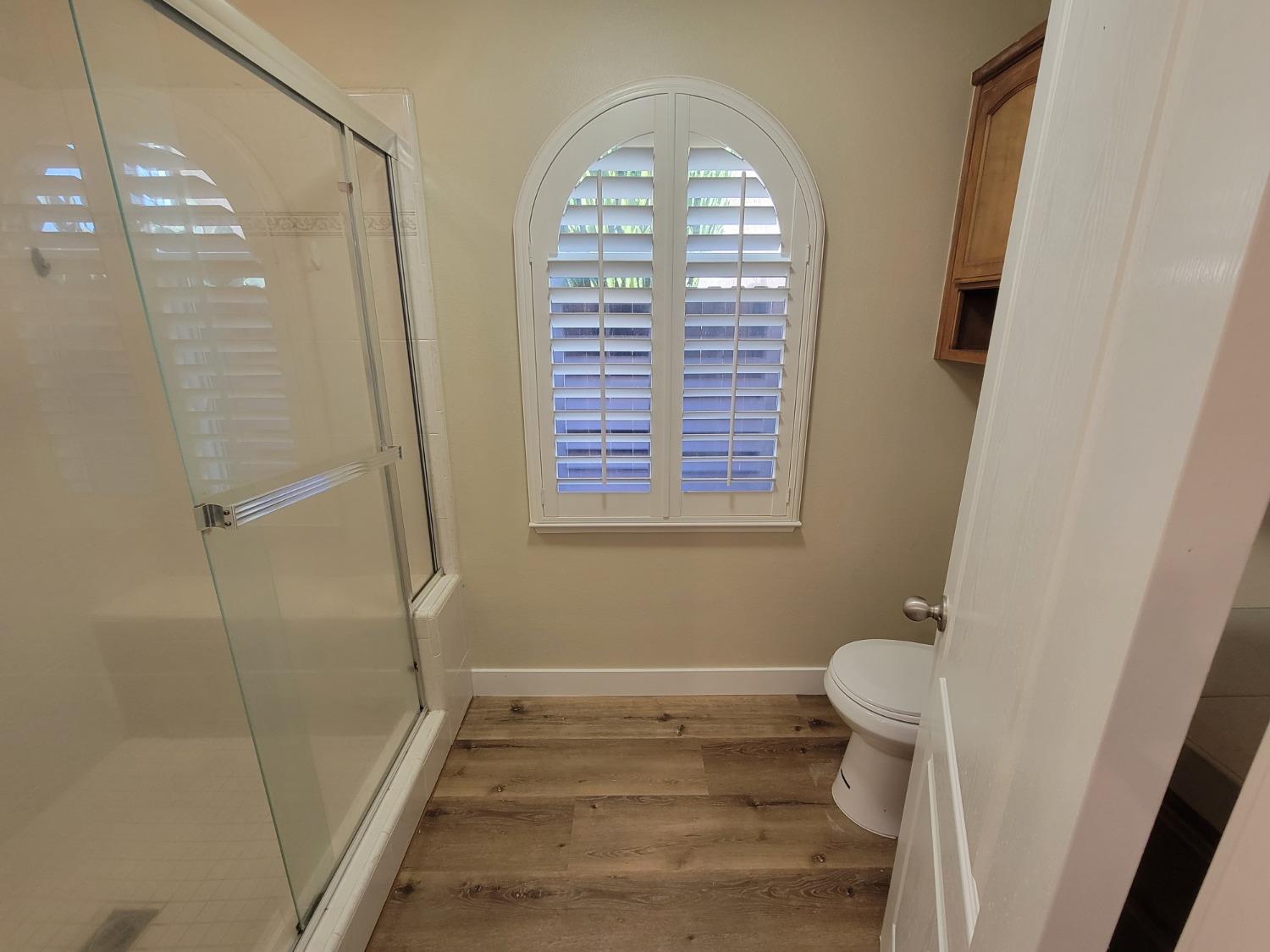 2831 Isabel Avenue Clovis, CA 93611 - Photo 15 of 27 a bathroom with a window and a shower