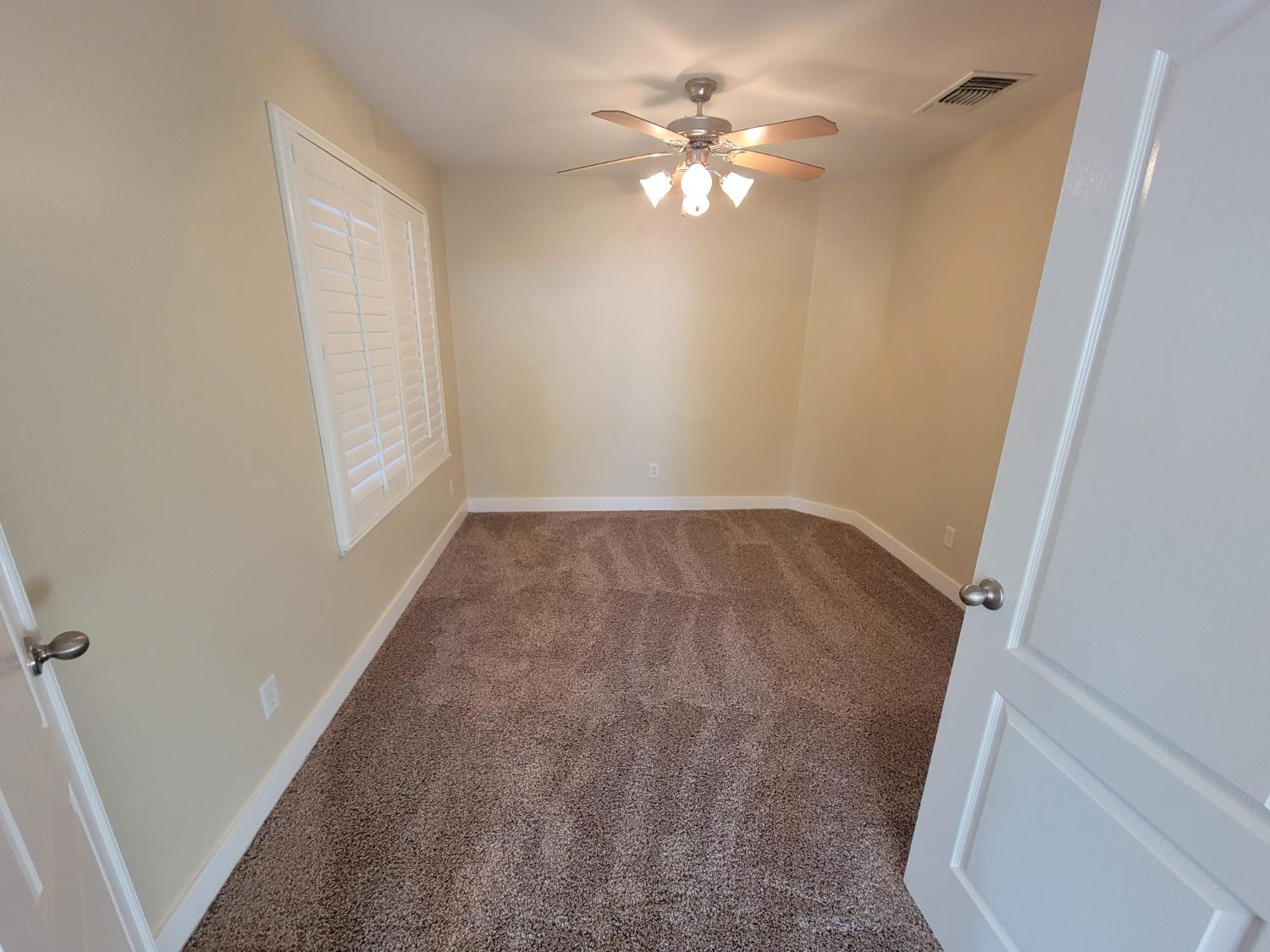 2831 Isabel Avenue Clovis, CA 93611 - Photo 18 of 27 an empty room with windows