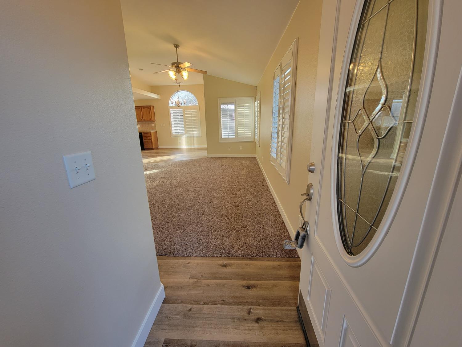2831 Isabel Avenue Clovis, CA 93611 - Photo 4 of 27 a view of a hallway with wooden floor and staircase