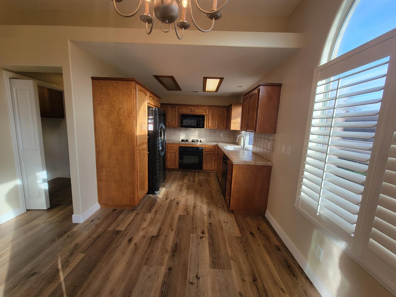 2831 Isabel Avenue Clovis, CA 93611 - Photo 8 of 27 a kitchen with a sink and wooden floor