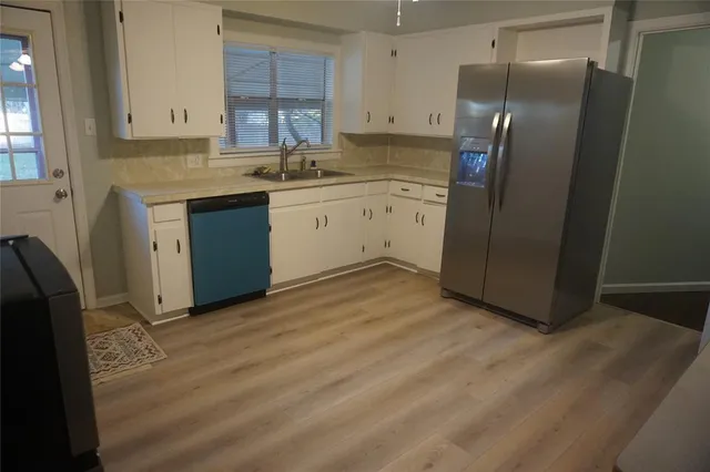 a kitchen with stainless steel appliances granite countertop a refrigerator sink and cabinets