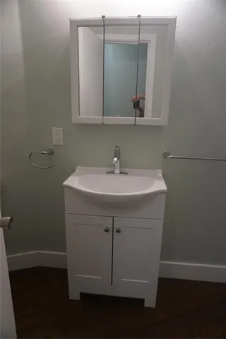 a bathroom with a sink and mirror