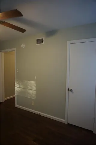 an empty room with wooden floor