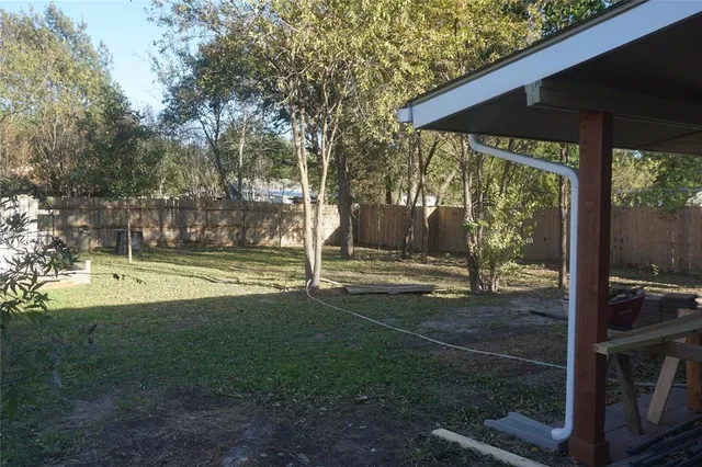 a view of a patio with table and chairs under an umbrella