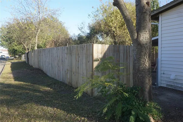 a wooden fence with trees in the background