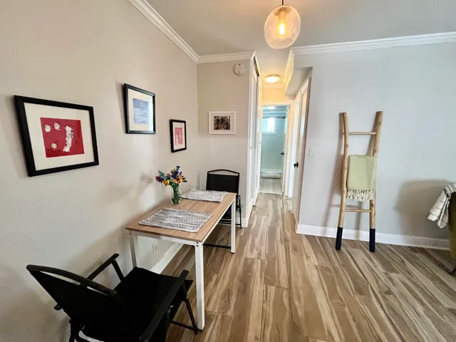 a view of a workspace with furniture and wooden floor