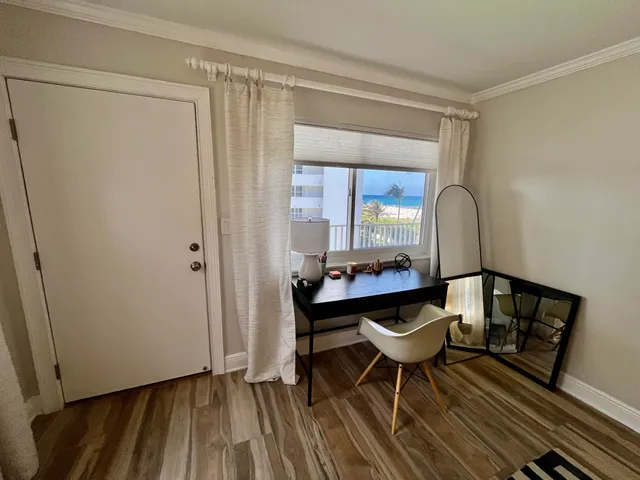 a view of a room with furniture and wooden floor