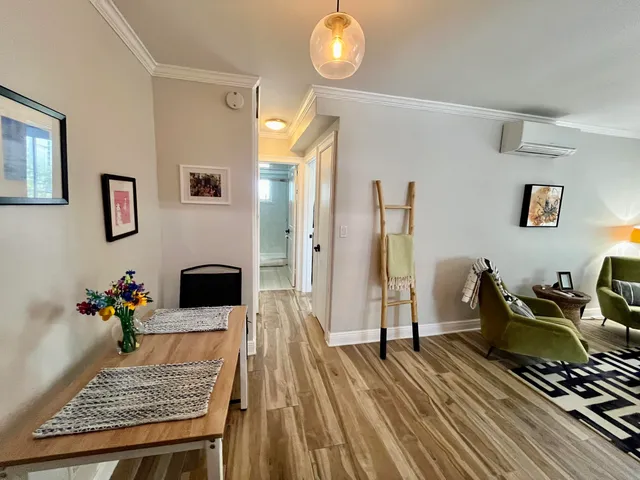 a living room with furniture and wooden floor