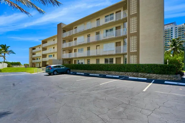 a view of sign board with potted plants