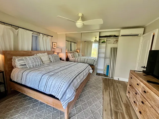 a bedroom with a bed and a flat screen tv