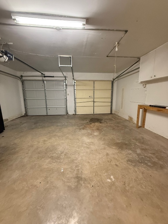 4603 Roundup Trail Austin, TX 78745 - Photo 15 of 35 Garage featuring a garage door opener