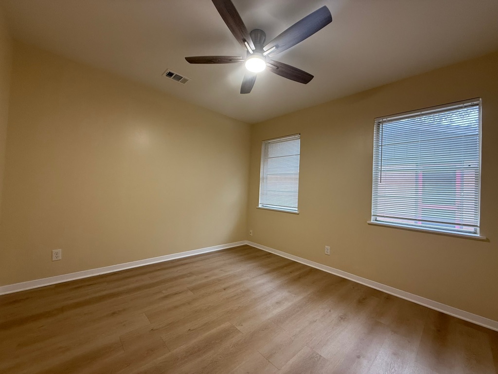 4603 Roundup Trail Austin, TX 78745 - Photo 28 of 35 Empty room featuring light wood-style flooring and ceiling fan
