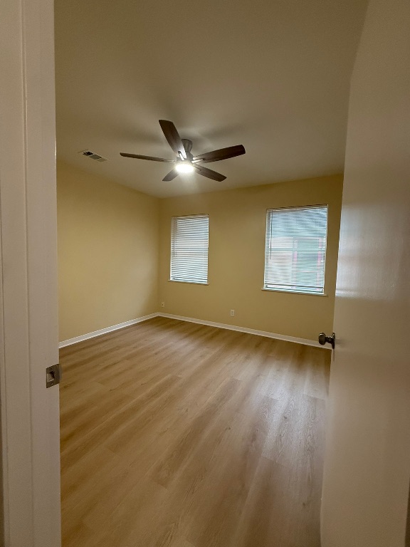 4603 Roundup Trail Austin, TX 78745 - Photo 4 of 35 Spare room featuring light wood-style flooring and baseboards