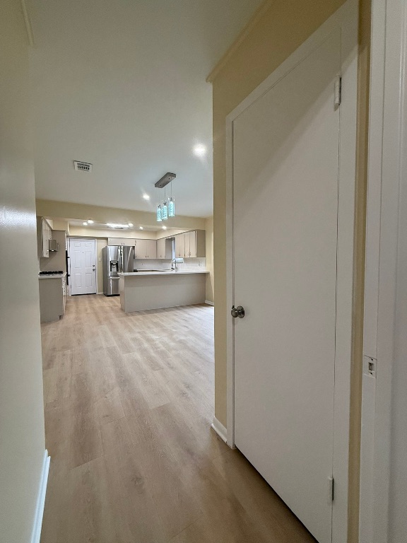 4603 Roundup Trail Austin, TX 78745 - Photo 5 of 35 Hallway featuring light wood-style flooring and recessed lighting