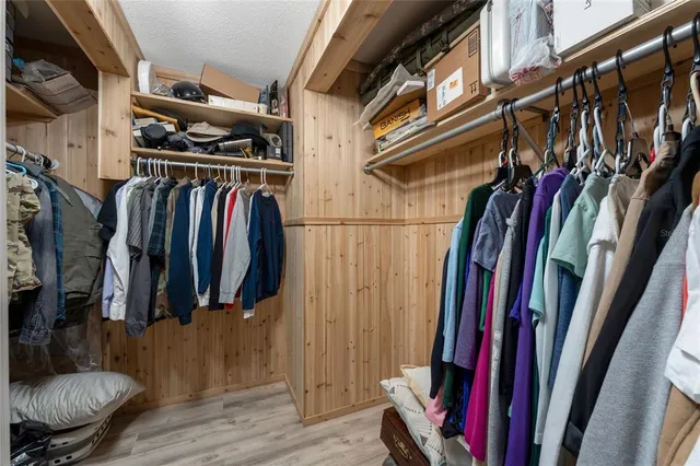 a work room with furniture a flat screen tv and a ceiling fan