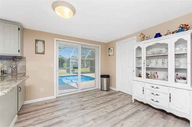 a kitchen with granite countertop a stove and a wooden floor