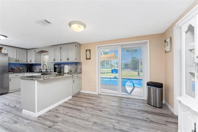 a kitchen with stainless steel appliances granite countertop a refrigerator and a stove top oven