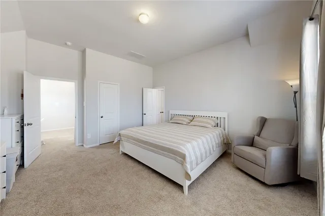 a bedroom with bed and a couch