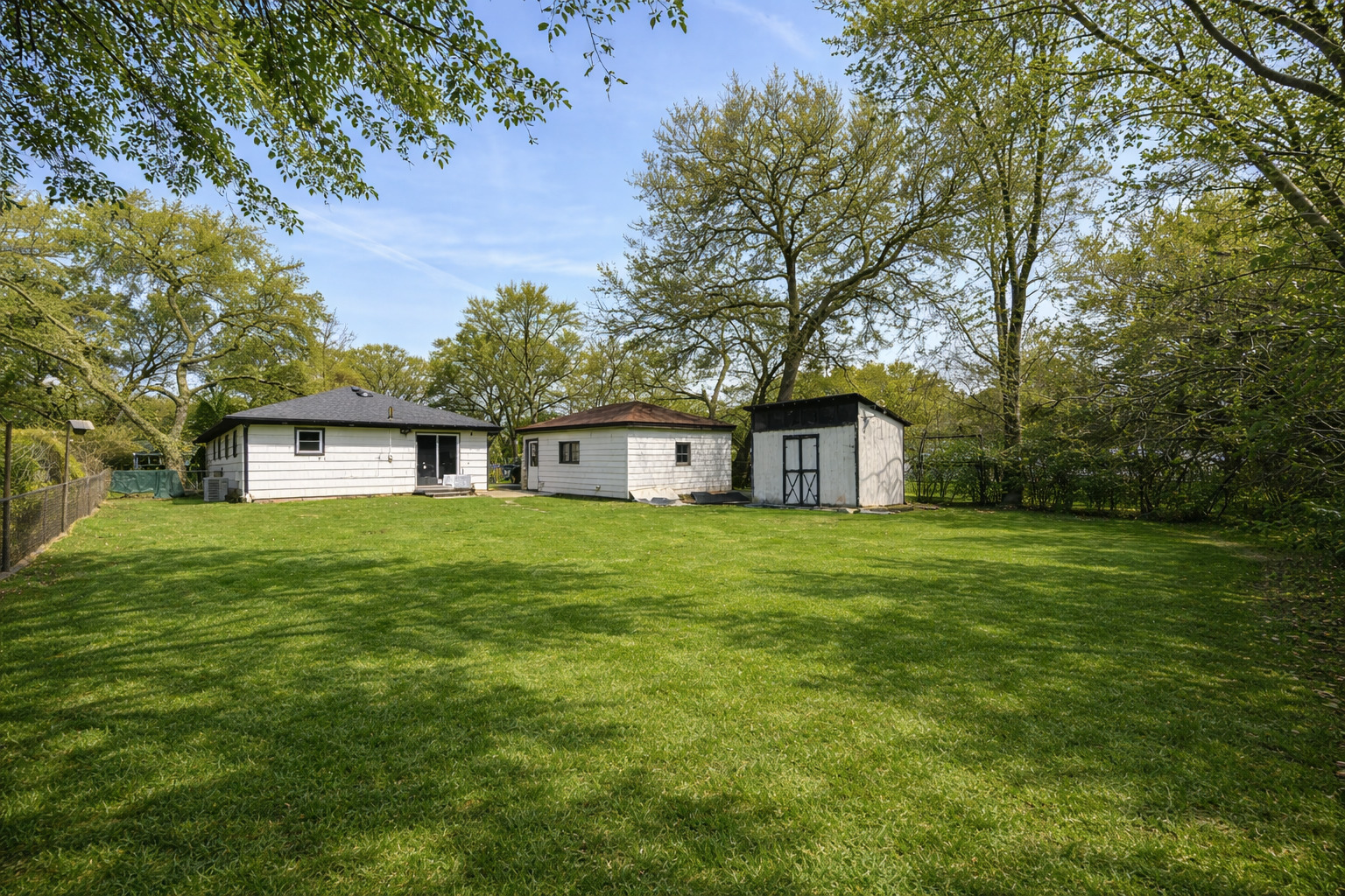 2109 Park Street Rolling Meadows, IL 60008 - Photo 18 of 19 a view of a big house with a big yard and large trees