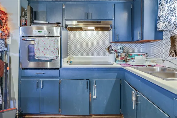 a kitchen with a sink and cabinets