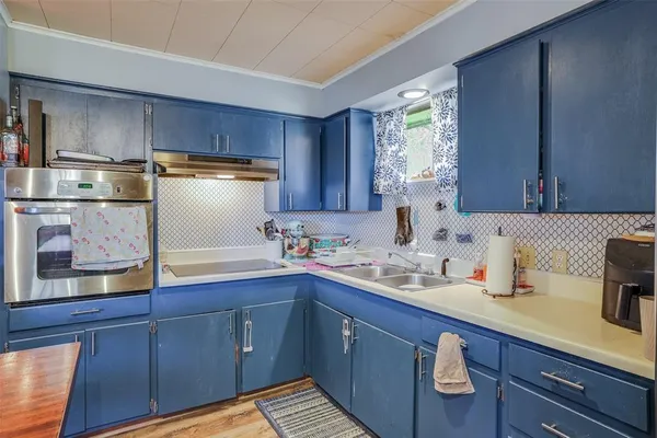 a kitchen with sink and cabinets