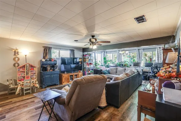 a living room with furniture a chandelier and a large window