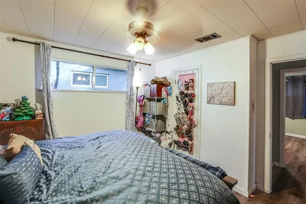 a bedroom with a bed and a chandelier