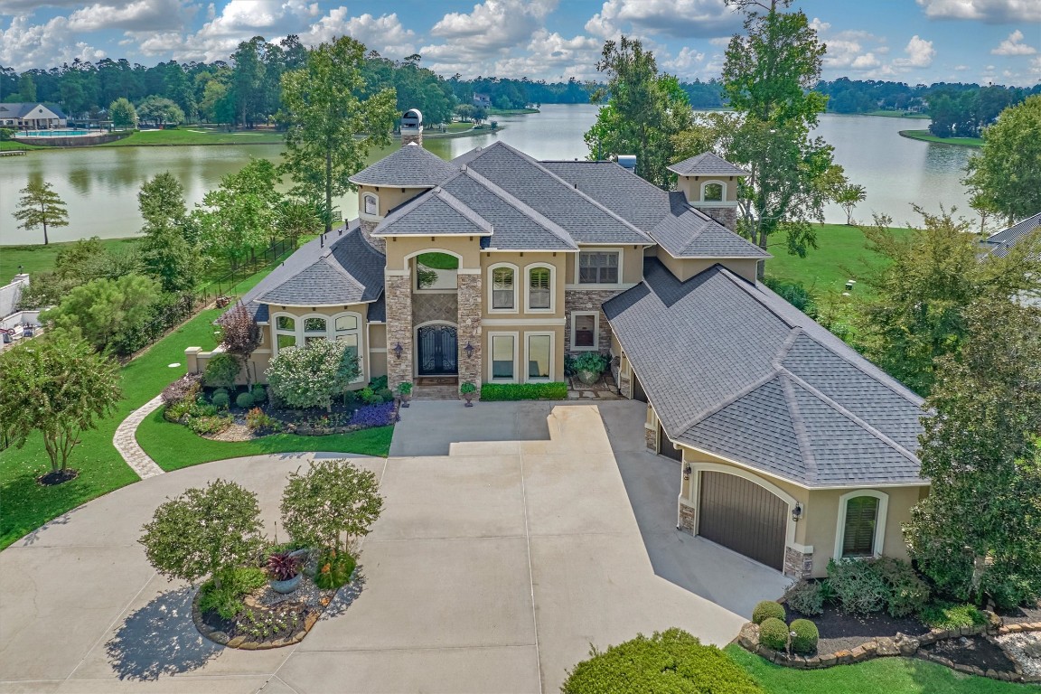 a aerial view of a house with yard and green space
