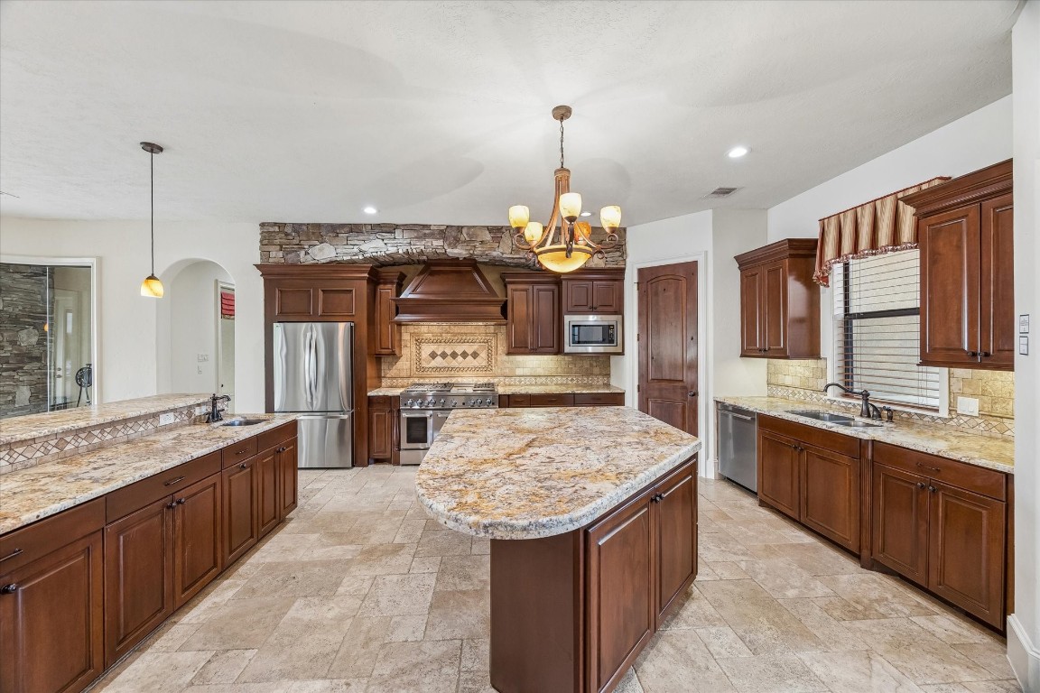 5402 White Birch Run Spring, TX 77386 - Photo 21 of 43 a kitchen with stainless steel appliances granite countertop counter space a sink and cabinets