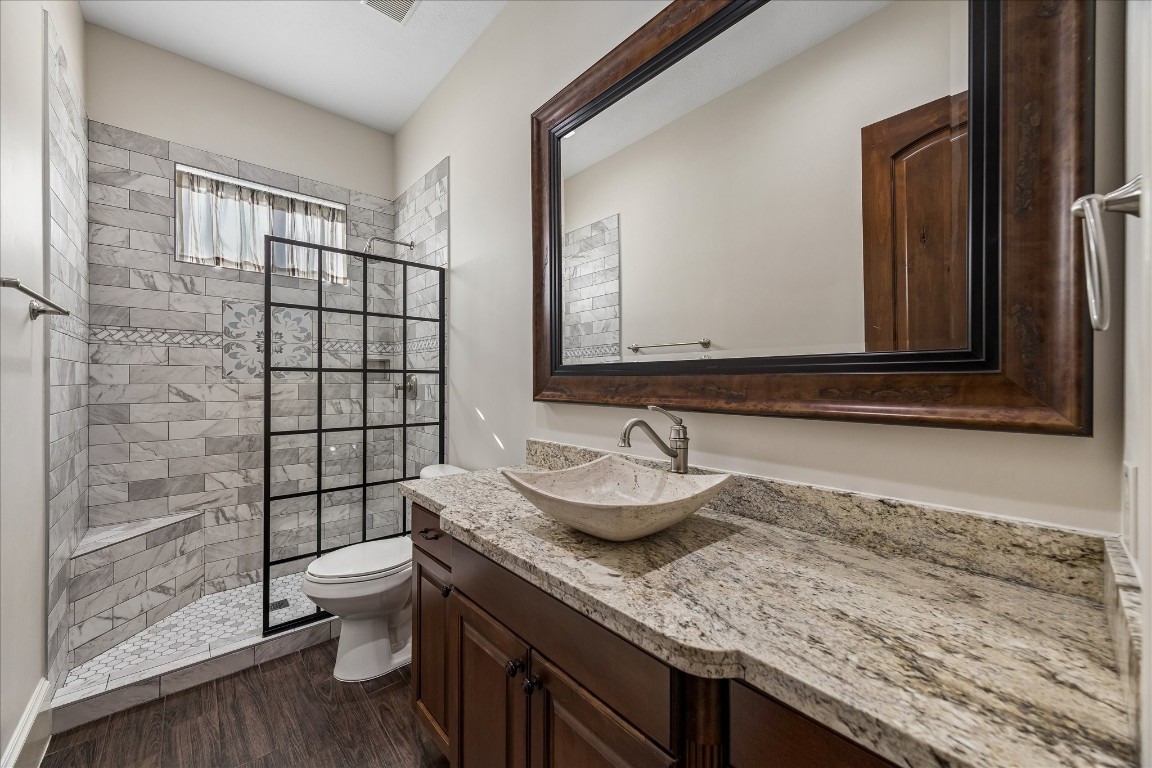 5402 White Birch Run Spring, TX 77386 - Photo 27 of 43 a bathroom with a granite countertop sink toilet and shower