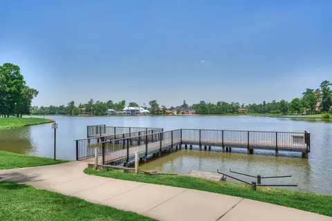 a view of a lake with houses in the back