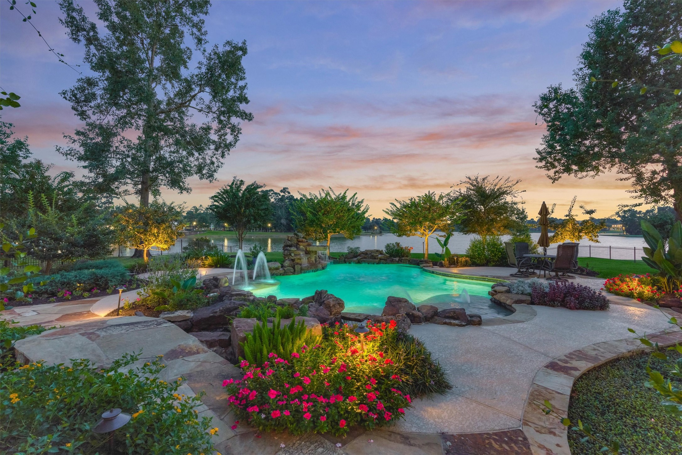 5402 White Birch Run Spring, TX 77386 - Photo 5 of 27 Resort style 7' deep pool has 2 waterfalls, beach entry with umbrella, gorgeous flower bed pockets surrounding the spa and cascading simulated river garden.