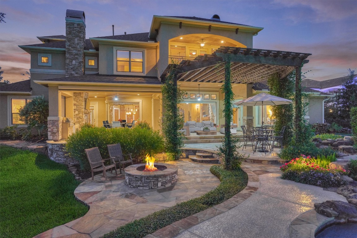 5402 White Birch Run Spring, TX 77386 - Photo 8 of 43 a view of a brick house with a yard and a table and chairs under an umbrella