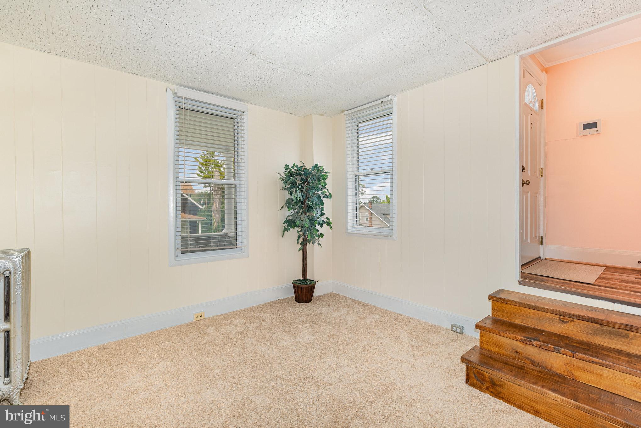 5005 Catalpha Road Baltimore, MD 21214 - Photo 14 of 31 a view of a bedroom with wooden floor and a window