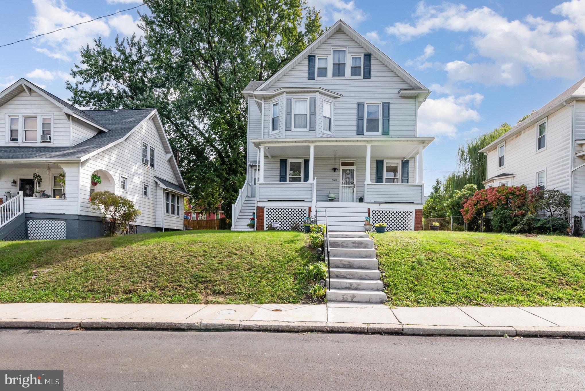 5005 Catalpha Road Baltimore, MD 21214 - Photo 2 of 31 a front view of a house with a yard and garage