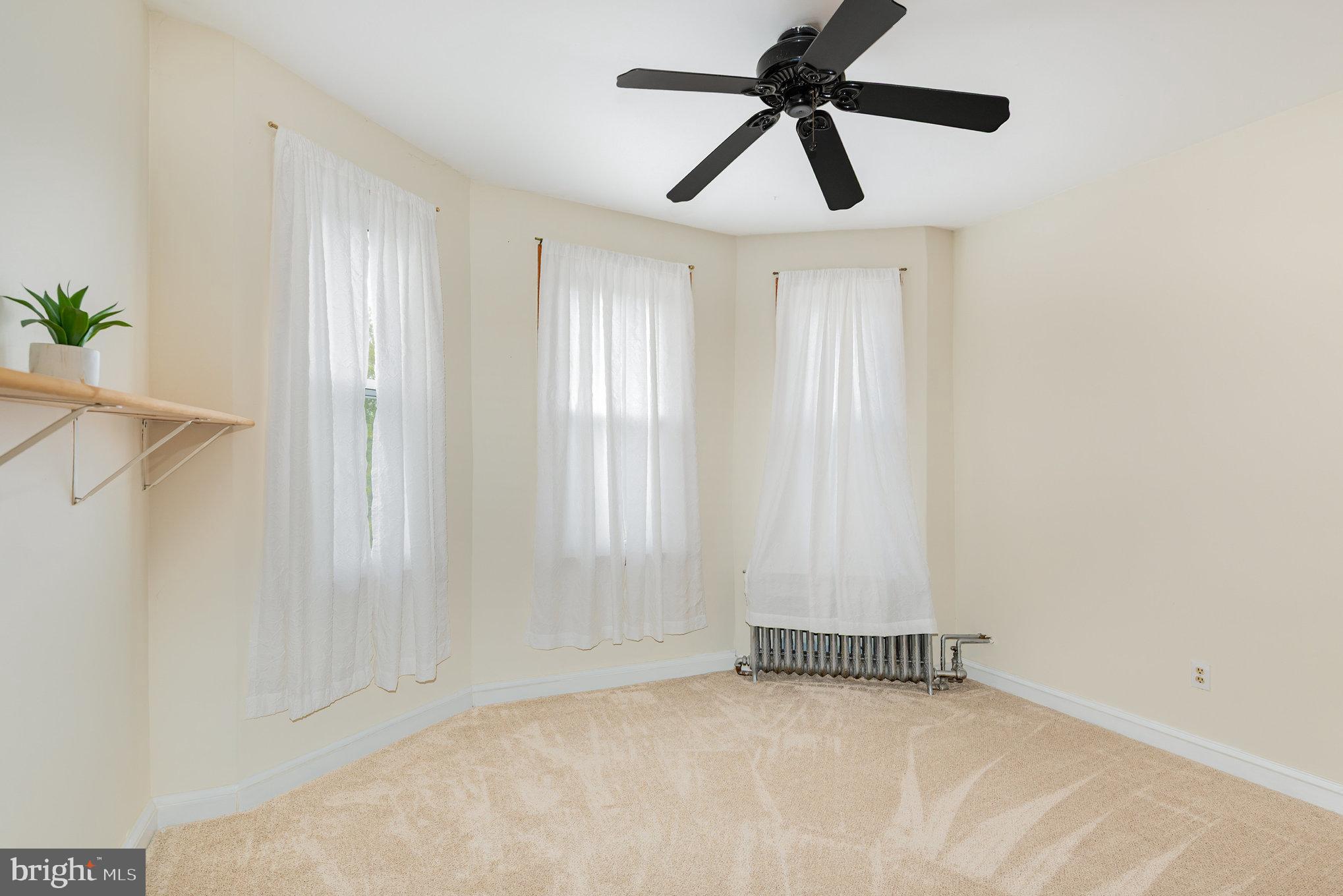 5005 Catalpha Road Baltimore, MD 21214 - Photo 21 of 31 an empty room with windows and closet