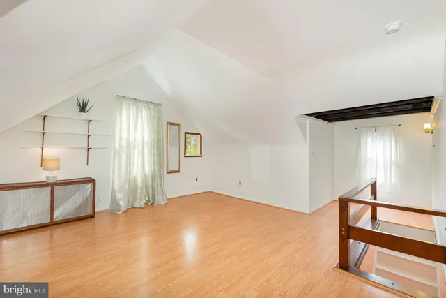 a view of a room with window and hardwood floor