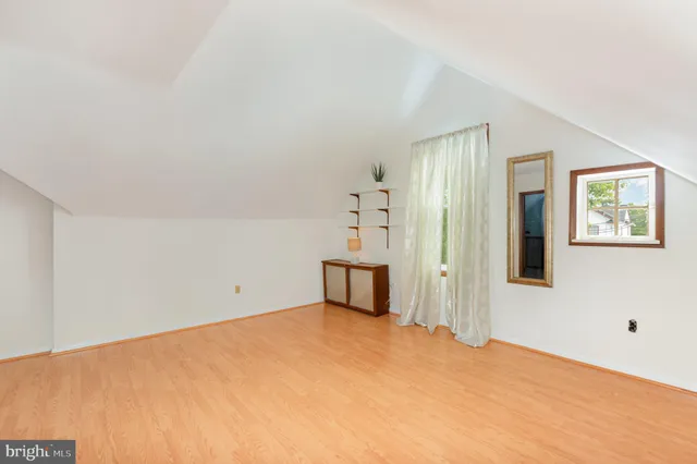 a big room with cabinet and mirror