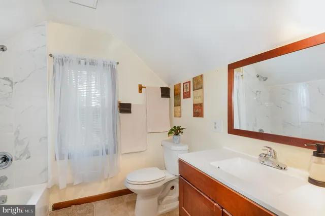 a bathroom with a sink toilet a mirror and shower