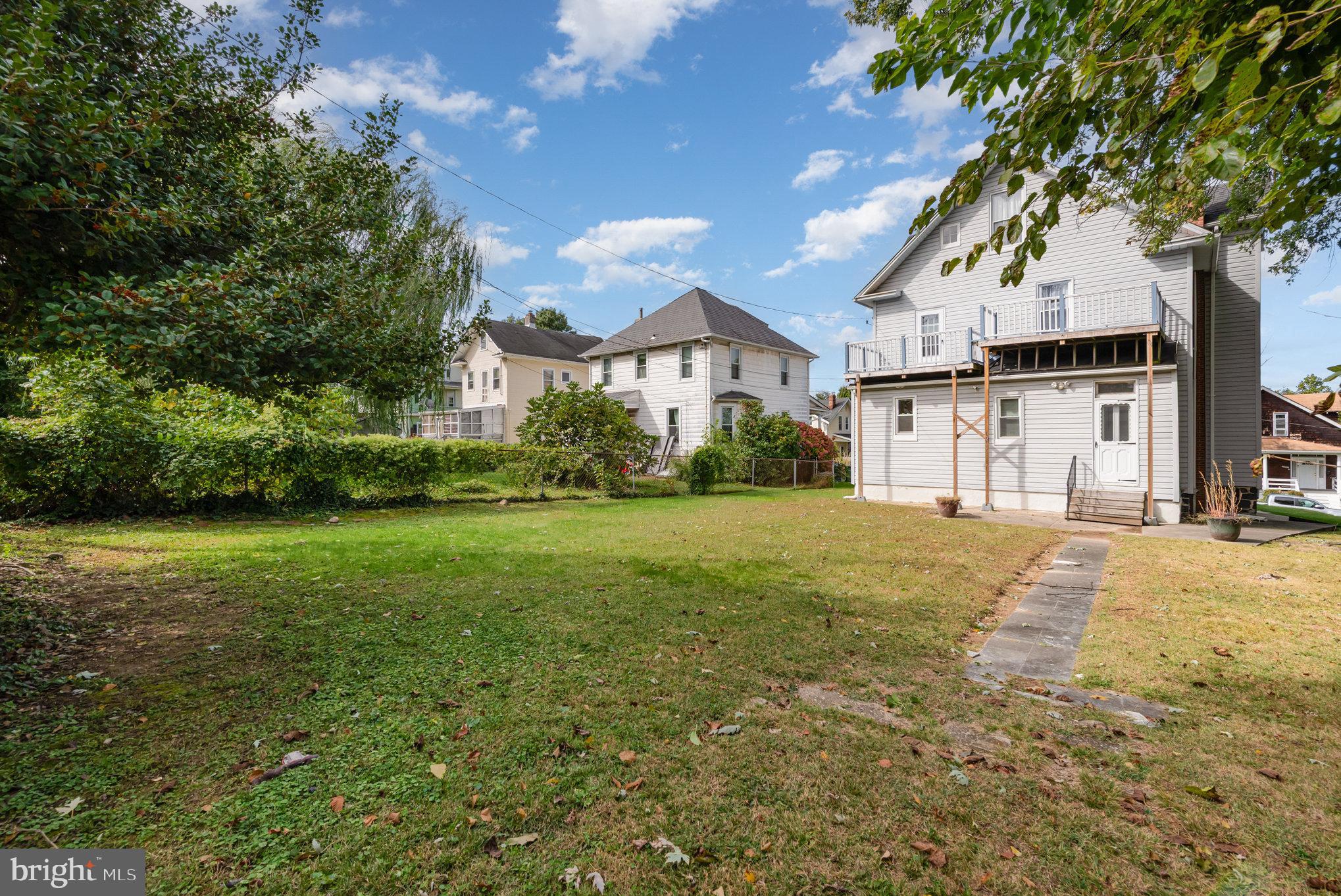 5005 Catalpha Road Baltimore, MD 21214 - Photo 31 of 31 a view of a big house with a big yard and large trees