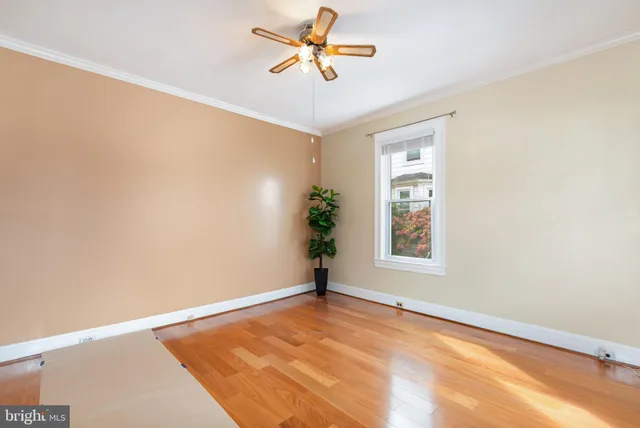 a view of a room with a ceiling fan and a window