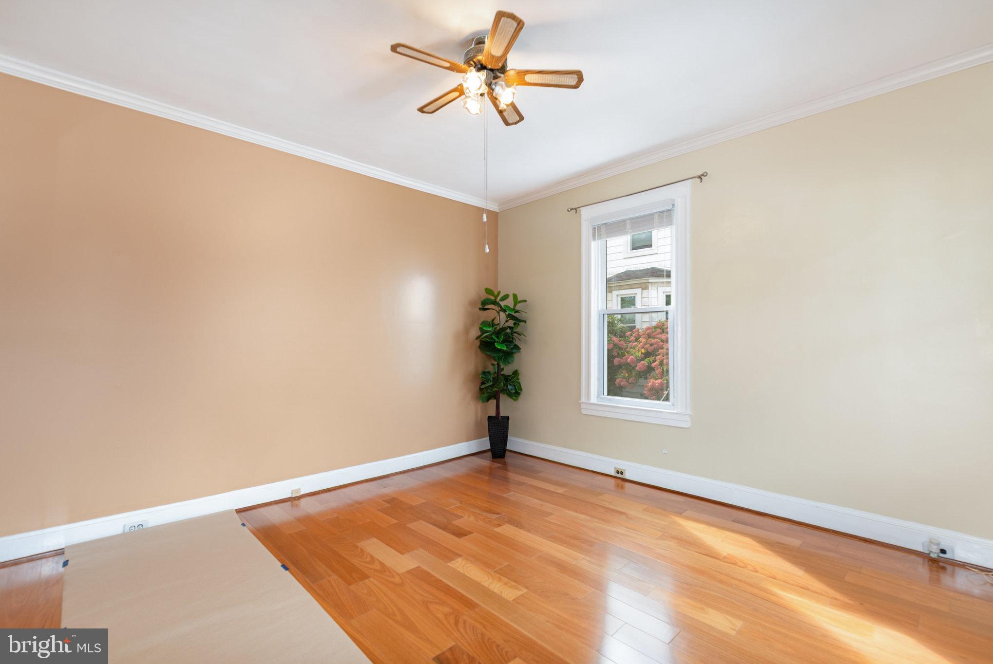 5005 Catalpha Road Baltimore, MD 21214 - Photo 6 of 31 a view of a room with a ceiling fan and a window