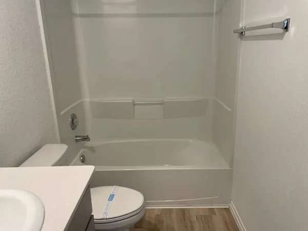 a bathroom with a toilet and a bath tub