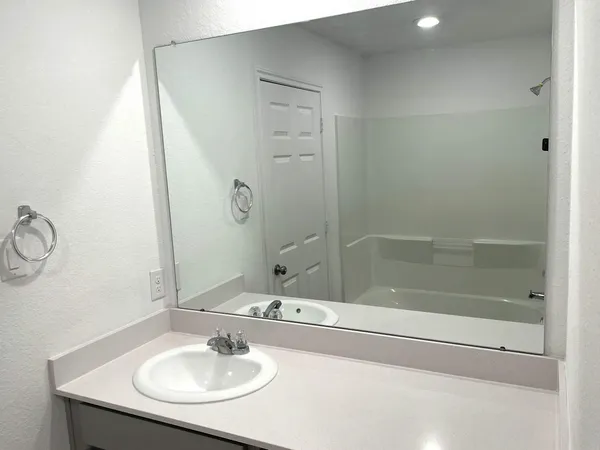 a bathroom with a sink and a mirror