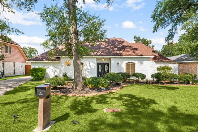 a front view of house with yard and green space