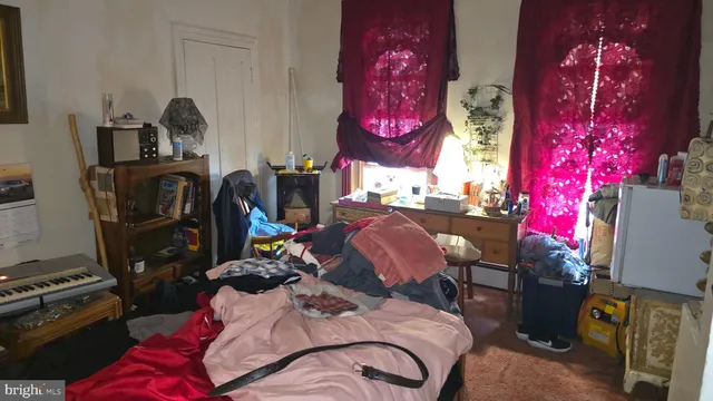 a bed sitting in a bedroom next to a window